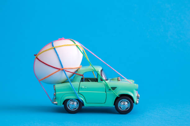 Close up of easter egg tied with multicolored strings on car abstract. stock photo