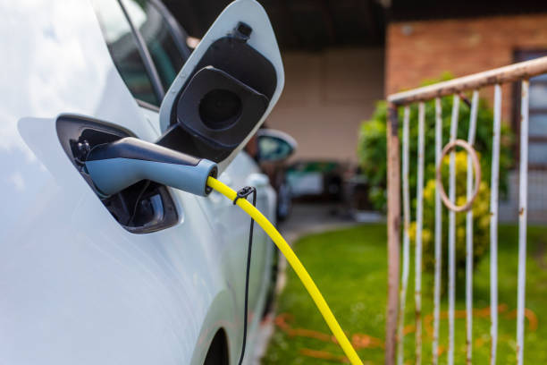 close up of electric car charger - car charger imagens e fotografias de stock