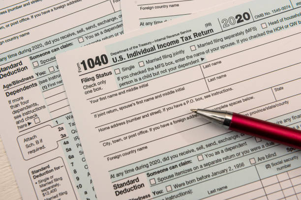 close up of empty us tax form 1040 and ballpoint pen stock photo