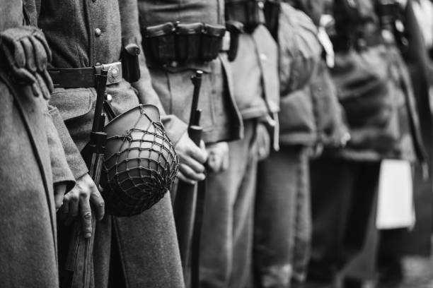 Close Up Of German Military Ammunition Of A German Soldier. World War II German Soldiers Standing Order. Photo In Black And White Colors. Soldiers Holding Weapon Rifle Close Up Of German Military Ammunition Of A German Soldier. Unidentified Re-enactors Dressed As World War II German Soldiers Standing Order. Photo In Black And White Colors. Soldiers Holding Weapon Rifles historical reenactment stock pictures, royalty-free photos & images