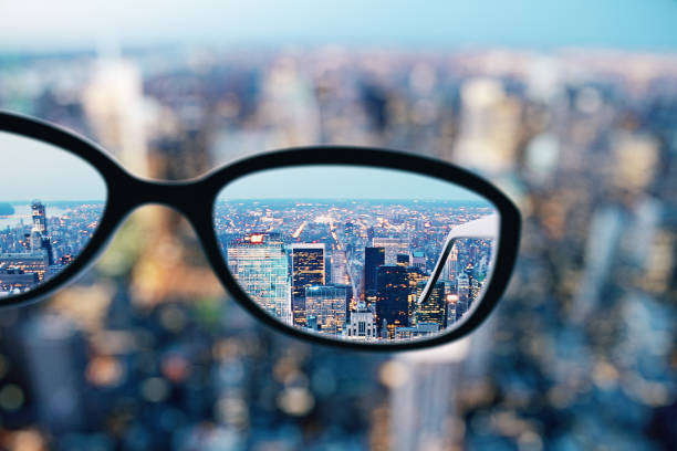 Close up of glasses in city Close up of glasses on blurry city background. Clean vision concept. 3D Rendering focus concept stock pictures, royalty-free photos & images