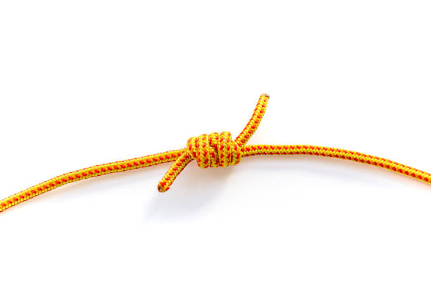 Close up of grapevine knot joining two rope strands. Macro of a double fisherman's bend done with 5mm yellow climbing rope. stock photo