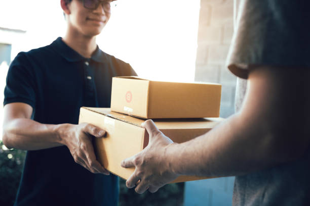 Close up of hands cargo staff are delivering cardboard boxes with parcels inside to the recipient's hand. Close up of hands cargo staff are delivering cardboard boxes with parcels inside to the recipient's hand. delivering stock pictures, royalty-free photos & images