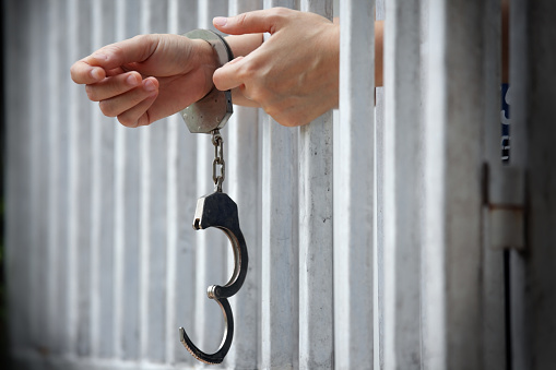 Close Up Of Hands In Jail Background Stock Photo - Download Image Now ...
