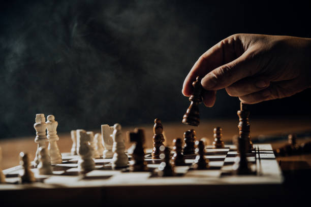 Close up of hands of men playing chess. stock photo