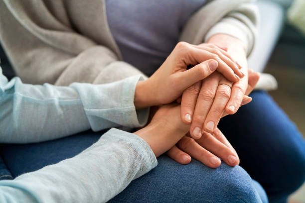 Close up of holding hands in a sign of support stock photo