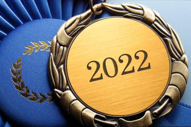 Close Up Of Medal Engraved With The Year 2022 Next To Blue Ribbon stock photo
