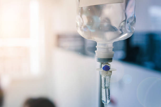 Close up of medical drip or IV drip Healthcare concept, Close up of medical drip or IV drip chamber in patient room, Selective focus. infused photos stock pictures, royalty-free photos & images