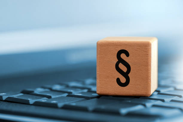Close up of paragraph character on wooden block on computer keyboard stock photo