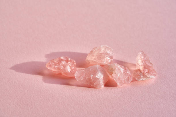 Close up of pink rose quartz crystals Rose quartz crystals on a pink background with copy space rose quartz stock pictures, royalty-free photos & images