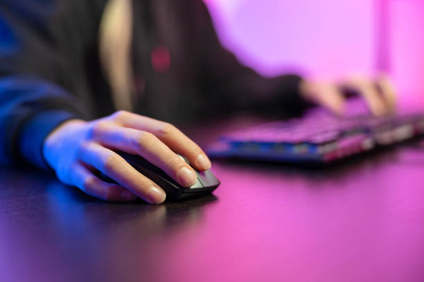 Close up of pro cyber sport gamer play game with keyboard and mouse stock photo