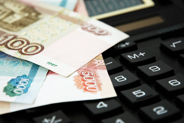 Close up of ruble banknotes on calculator. Financial accounting, pension reform and savings concept. stock photo