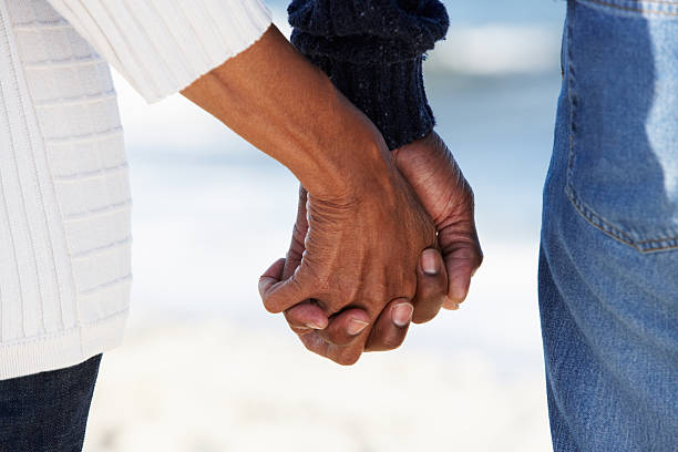 Close Up Of Senior Couple Holding Hands Close Up Of Senior Couple Holding Hands On Beach old black couple in love stock pictures, royalty-free photos & images