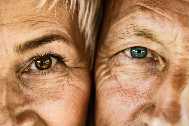 Close up of senior couple looking at camera. Close up of mature couple looking at camera. eye close up stock pictures, royalty-free photos & images