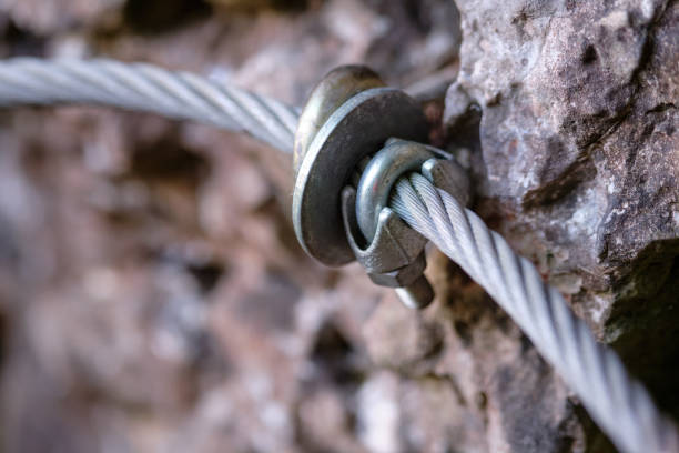 Close - up of steel wire rope along hiking trail stock photo