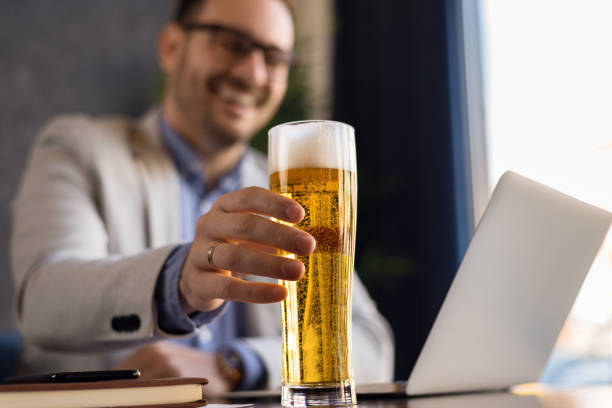 Close up of unrecognizable man drinking  beer. stock photo