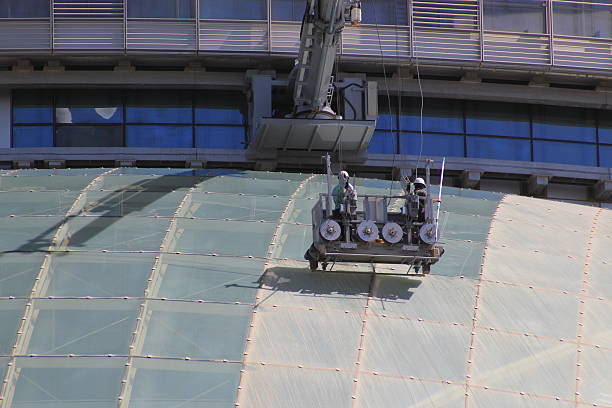 Close up of window washers cleaning a modern skyscraper stock photo