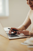 istock Close Up of Woman Hands Typing Business Report on a Laptop Computer 1350926611