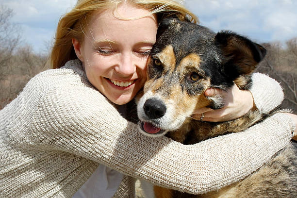 Close up of Woman Hugging German Shepherd Dog stock photo