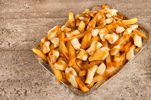 Close up on a poutine in a takeout container. stock photo