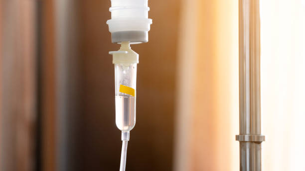 close up on tube of IV chemical pharmaceutical liquid at patient's room in hospital for intensive unit care  infusion therapy stock pictures, royalty-free photos & images