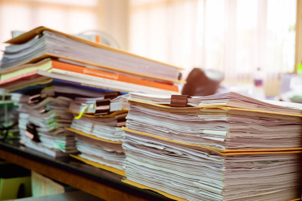 Close up paper stack on the desk related to business functions.Stack of business document files,report paper of accounting and financial with morning light,soft focus stock photo