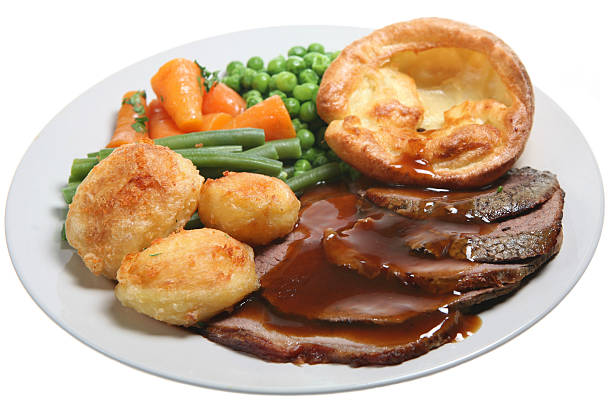 Close up photo of a roast beef, potatoes and veggies dinner Traditional Sunday roast beef dinner with Yorkshire pudding, roast potatoes and vegetables roast dinner stock pictures, royalty-free photos & images