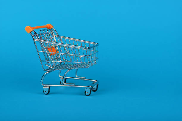 Close up retail shopping cart on blue background stock photo