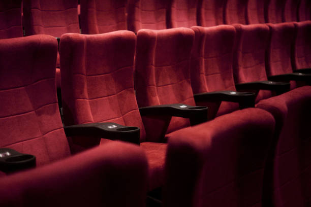 Close up shot of empty red cinema seats in a movie theater stock photo