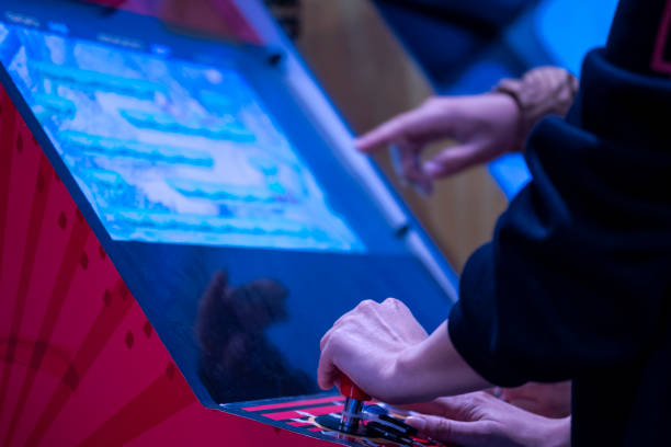 Close up shot of person playing with a arcade machine stock photo