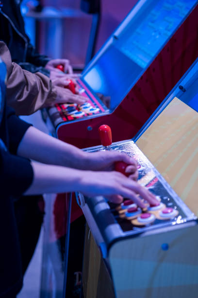 Close up shot of person playing with a arcade machine stock photo