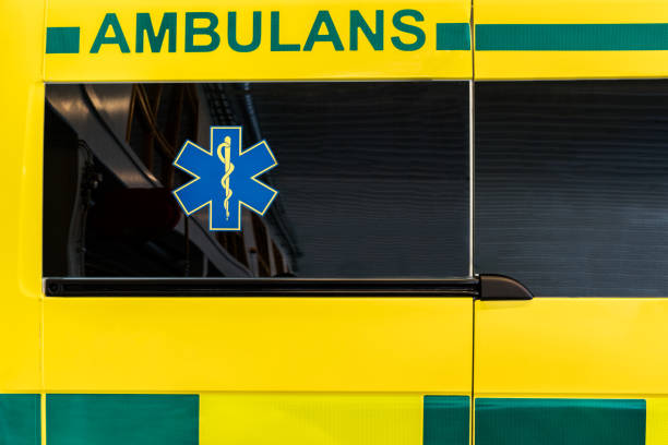 Close up side view of a yellow and green Swedish ambulance vehicle. stock photo