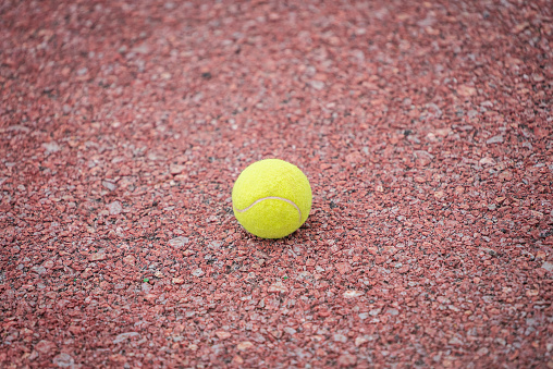 Close up single Tennis ball on court background with copy space