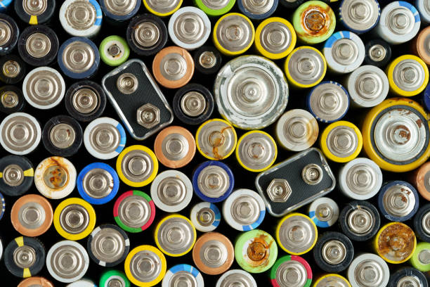 Close up top view of used battery. Electronic hazardous waste concept. Batteries background stock photo