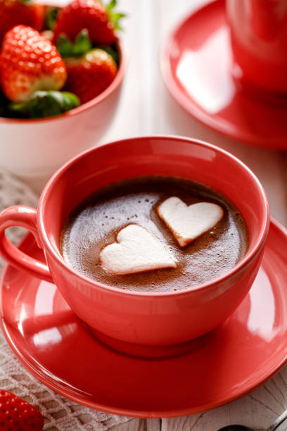 Close up view of hot chocolate with heart-shaped marshmallows stock photo