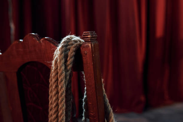 close up view of knot that hanging on the red chair on the stage of theater - ropes backstage theater imagens e fotografias de stock