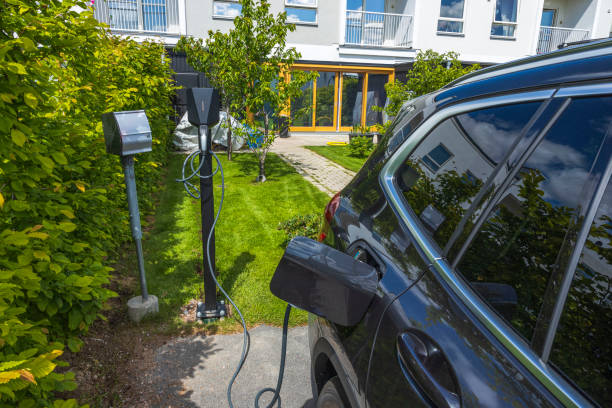 Close up view of parked vehicle connected to charging station. Sweden. stock photo