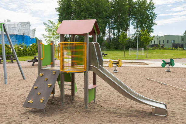 Close up view of slide on empty playground on summer day. stock photo