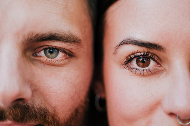 close up view of young happy couple together. Eyes close up. Love and family concept close up view of young happy couple together. Eyes close up. Love and family concept brown eyes stock pictures, royalty-free photos & images