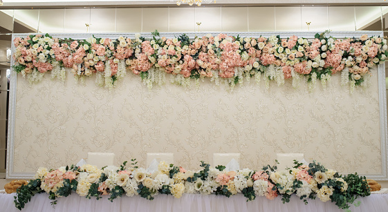 Close up wedding table decoration with white flowers peonies and roses, with space for you text