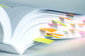 istock Close up White book marked by sticky note 849636584