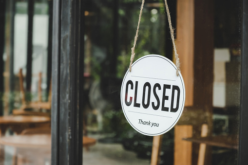 Closed. coffee cafe text on vintage sign board hanging on glass door in modern cafe coffee shop, reopening cafe restaurant, retail store, small business owner, takeaway food, food and drink concept