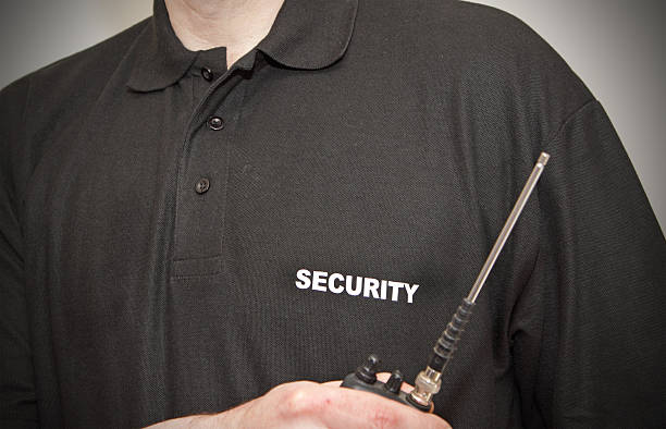 Close-up a security guard's black polo and walkie talkie stock photo