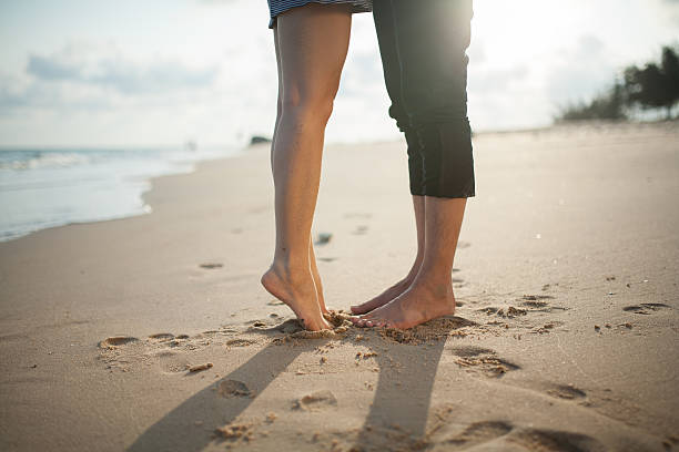 Closeup barefoot couple legs at the beach Closeup barefoot couple legs at the beach human limb photos stock pictures, royalty-free photos & images