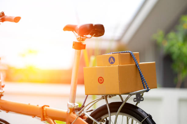 Closeup Delivered package parcels box on bicycle outdoors to deliver. stock photo