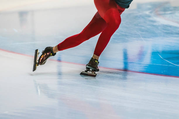 closeup feet girl skater riding on ice stock photo