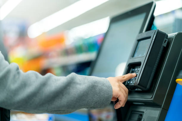 closeup hand press button code for input access password at counter cashier machine with monitor in supermarket store - balcão computador imagens e fotografias de stock