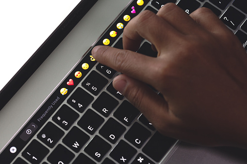Close-up hand touching on touch bar on new macbook pro
