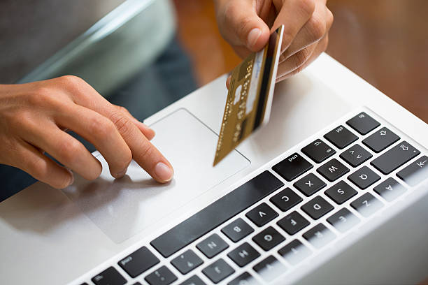 Close-up hand woman using laptop and credit card, online shopping stock photo