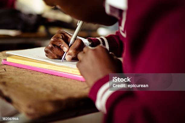 Closeup image of South African girl writing at her desk